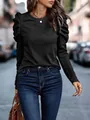 Detail of a chic black long-sleeved top with elegant puff shoulders and a round neckline. - S / Tops / Black