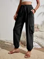 Detailed view of women's black casual cargo pants featuring functional flap pockets - S / Bottoms / Black