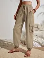 Women's khaki cargo pants with drawstring waist and pockets in a patio setting - S / Bottoms / Khaki