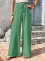 Detailed view of green bubble grid textured wide-leg casual pants for women. - Bean Green