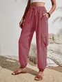 Detailed view of dusty rose cargo pants featuring large side pockets and drawstring waist - S / Bottoms / Pink