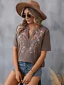 Detailed view of a fashion women's t-shirt with floral embroidery and lace trim - S / Tops / Dark Brown