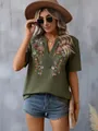 Detailed view of green boho top with intricate floral embroidery and lace V-neck trim - S / Tops / Army Green