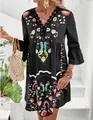 Close-up of black bohemian floral print dress with V-neck lace trim and bell sleeves - S / Black