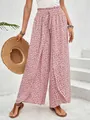 Close-up of pink floral wide-leg pants with a stylish side slit and elastic waist - S / Bottoms / Pink