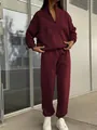 Detail of burgundy two-piece fleece tracksuit with half-zip pullover and joggers - Burgundy