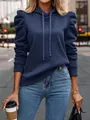 Detail of navy blue hooded sweatshirt featuring stylish puff sleeves and drawstring hood. - Blue