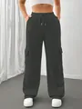 Close-up of charcoal grey wide-leg cargo sweatpants with side pockets on a model - S / Bottoms / Dark Gray