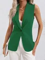 Detail showing the green sleeveless blazer with a sharp lapel and single button closure. - Green
