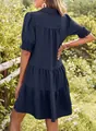 Detailed back view of a navy blue tiered dress with textured fabric and puffed sleeves - S / Dresses / Navy Blue