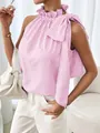 Detalle de la blusa sin mangas a rayas rosas con cuello de volantes y lazo decorativo lateral - S / Tops / Rosa