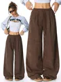 Detailed view of brown corduroy wide-leg pants with high waist and drawstring - S / Bottoms / Coffee