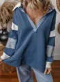 Close-up detail of a deep V-neck striped patchwork loose blue long sleeve sweatshirt - Navy Blue