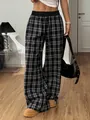 Macro detail of high-waisted plaid trousers showing drawstring waist and fabric texture - S / Bottoms / Black