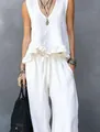 Lifestyle view of white linen sleeveless ruffle top and wide-leg trousers set - White
