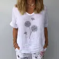 Detail view of a white linen V-neck T-shirt with black dandelion dot print on a model - S / Tops / White