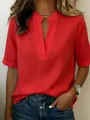 Close-up detail of a vibrant red women's casual V-neck blouse with short sleeves - Red