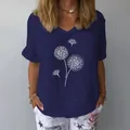 Detailed view of the white dandelion print on a navy blue V-neck cotton linen top - S / Tops / Navy Blue