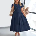 Navy blue V-neck tiered maxi dress with short puff sleeves in a stylish indoor setting - Navy Blue