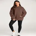 Full body detail of a women's brown oversized hoodie paired with black sports leggings - Dark Brown