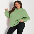 Premium light green oversized hoodie for women featuring a front pocket and soft fabric. - S / Tops / Light Green