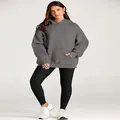 Close-up detail of women's oversized grey hoodie featuring pocket and drop shoulder design - Dark Gray