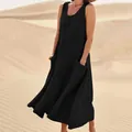 Elegant sleeveless black cotton linen maxi dress with pockets shown in a desert landscape - S / Black