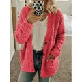Detailed view of pink fuzzy cardigan featuring a textured fleece finish and pockets - S / Tops / Pink