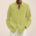 Close-up of men's loose linen shirt featuring button-down design and breathable fabric. - S / Yellow