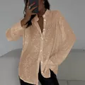 Close-up detail of champagne gold sequined long sleeve shirt with classic lapel collar - S / Tops / Champagne