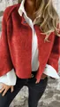 Detail shot of a vibrant red textured cashmere short jacket with white shirt - Brick Red