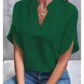 Close-up of a dark green V-neck blouse with loose short sleeves for a casual summer look. - Dark Green
