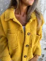 Macro view of a cozy mustard yellow sherpa jacket showing fabric texture and buttons - S / Tops / Yellow