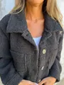 Detailed view of a black fuzzy lambswool jacket featuring a classic lapel and stylish buttons - S / Tops / Black