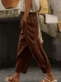 Detail of brown cotton linen trousers with drawstring elastic waist and side pockets. - Dark Brown