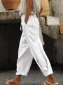 Detail shot of white linen wide-leg pants with elastic drawstring waist and side pockets - S / Bottoms / White