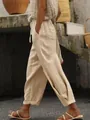 Detailed side view of women's beige linen trousers with elastic waist and side pockets - Khaki