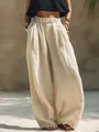 Vista detallada de los pantalones anchos de lino crema con cintura elástica y bolsillos - S / Bottoms / Blanco Roto