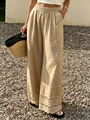 Détail du bas de pantalon en lin beige avec bordure en dentelle crochetée chic - S / Bas / Kaki