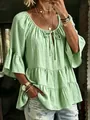 Detail view of a light green ruffled tier blouse featuring textured fabric and 3/4 bell sleeves. - Light Green