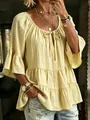Detail view of yellow ruffled blouse with textured fabric and tie-up neckline - Yellow