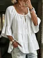 Detailed view of white pleated blouse with tie-neck and ruffled three-quarter sleeves. - S / Tops / White