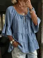 Detailed view of women's blue ruffled blouse featuring a tie-neck and textured bell sleeves. - S / Tops / Blue