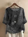 Detailed view of women's grey printed blouse with decorative buttons and necklace accessory - S / Tops / Gray