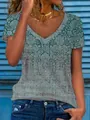Dettaglio di un top ampio da donna con scollo a V e una stampa floreale stile vintage - Taglia S / Top / Verde