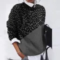 Close-up of the vintage leopard print and solid grey color-block fabric on long sleeve top - Gray Leopard Patch