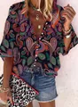 Detail of women's retro paisley print button-up blouse with boho jewelry and denim shorts. - S / Tops / Navy Paisley Print