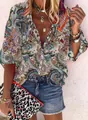 Detailed view of women's vintage paisley print blouse with V-neck and button closure - S / Tops / Cream Complex Paisley Print