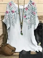 Close-up detail of women's loose round neck blouse featuring pink floral and vine print - S / Tops / Light Blue Floral (Image 18)