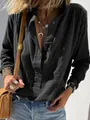 Detail view of a black cotton linen shirt featuring a textured fabric and button-up collar. - S / Tops / Black